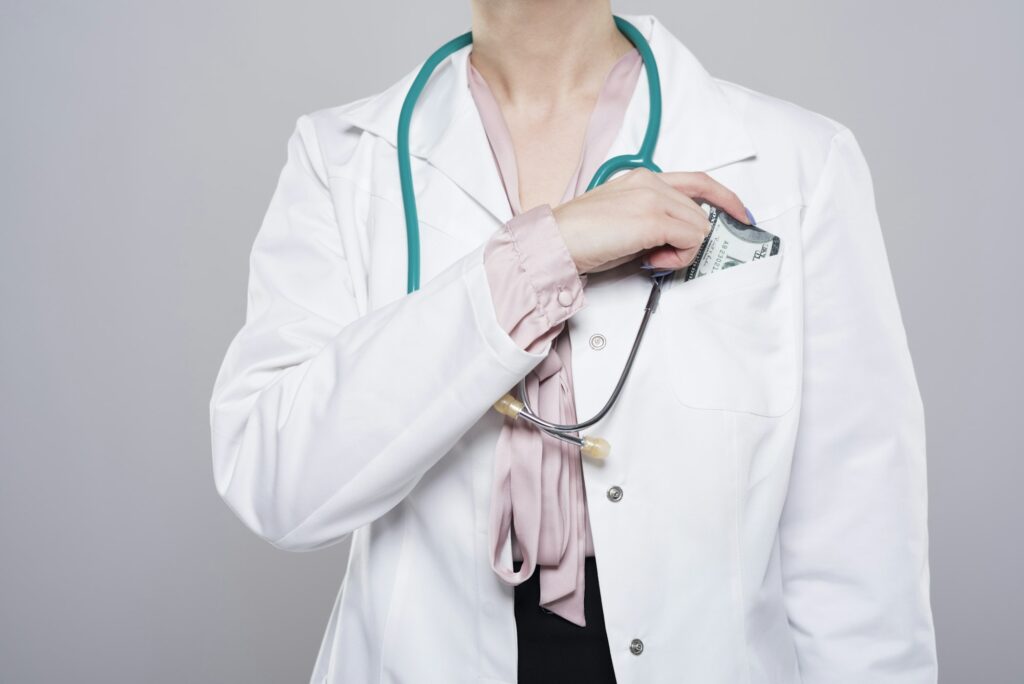 Doctor putting bribe into her pocket