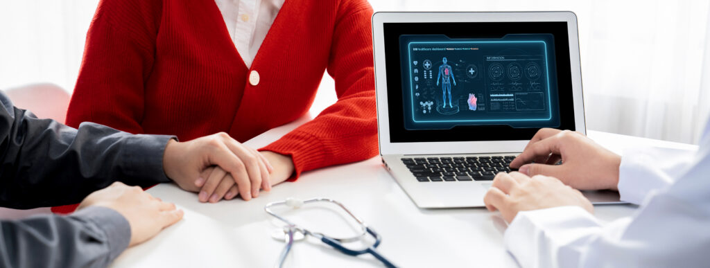 A couple receiving a diagnosis from a healthcare professional using a laptop. Healthcare fraud concept.