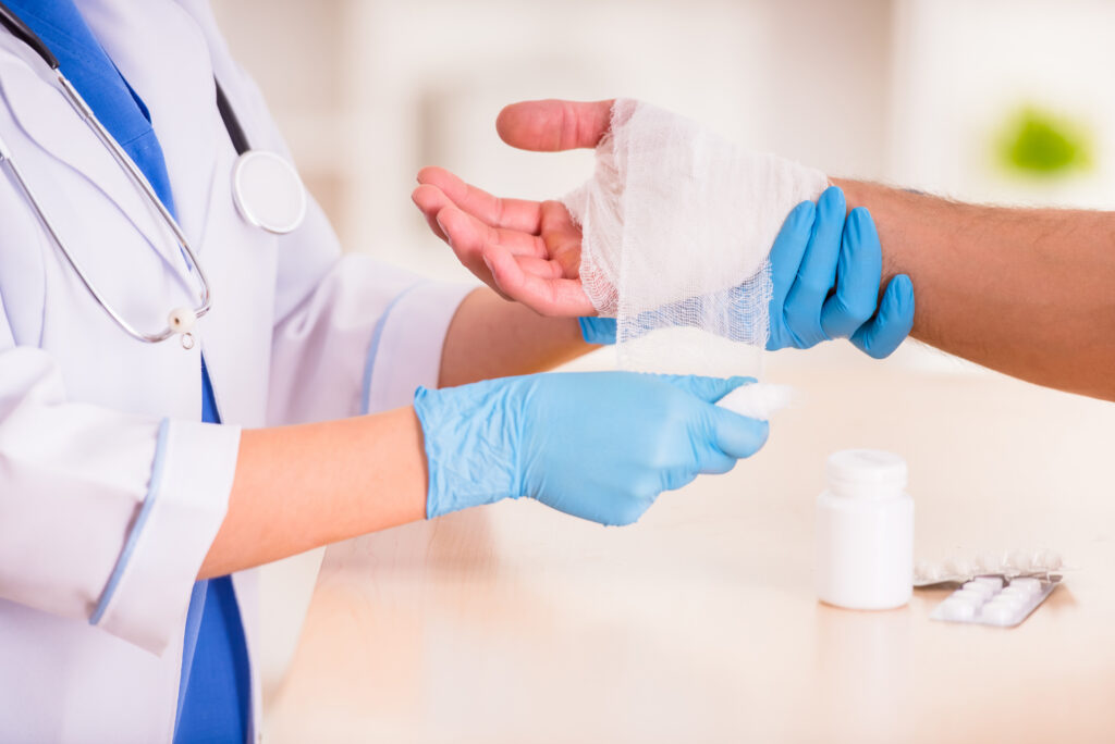 Medical professional wrapping a patient's wound. Healthcare fraud concept.